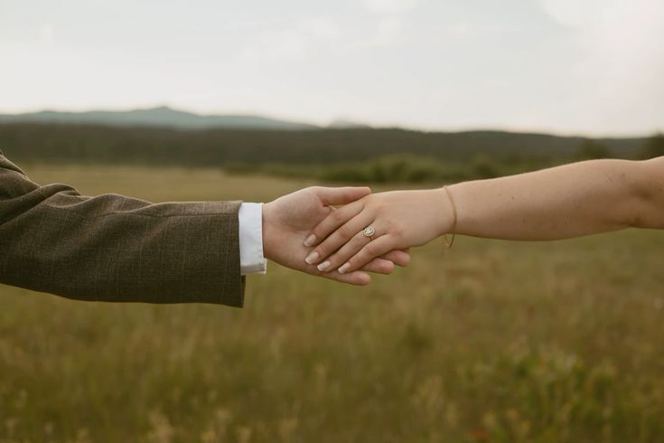 Material Science: Couple holding hands with diamond ring